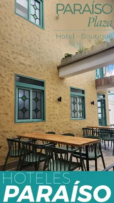 a group of tables and chairs in front of a building at Paraíso Plaza - Hotel Boutique in Aguadas