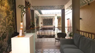 a living room with a couch and a balcony at Paraíso Plaza - Hotel Boutique in Aguadas