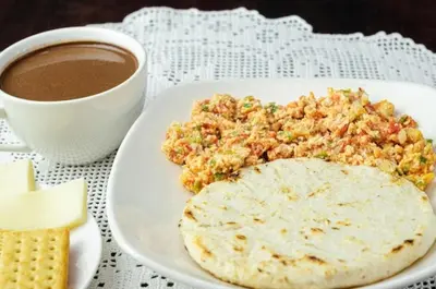 a plate of food and a cup of coffee at Paraíso Plaza - Hotel Boutique in Aguadas