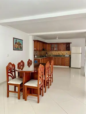 a kitchen with a table and chairs and a refrigerator at Apartamento Luz De Luna in Jardin