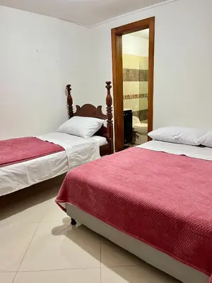a bedroom with two beds and a mirror at Apartamento Luz De Luna in Jardin