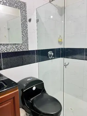 a bathroom with a black toilet and a glass shower at Apartamento Luz De Luna in Jardin