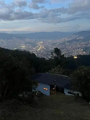 a house sitting on top of a hill with a city at Cabañas DALI la catedral in Envigado