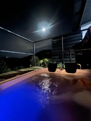 a swimming pool at night with a light at Cabañas DALI la catedral in Envigado