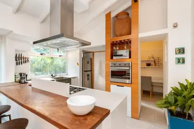 a kitchen with white counters and a counter top at Homely Penthouse in Provenza in Medellín