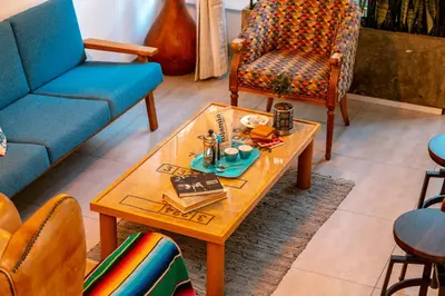 a living room with a coffee table and chairs at Homely Penthouse in Provenza in Medellín