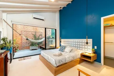 a bedroom with a bed and a hammock in it at Homely Penthouse in Provenza in Medellín