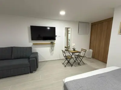 a living room with a couch and a table at Nuevo apartamento en plaza principal de Guatape in Guatapé
