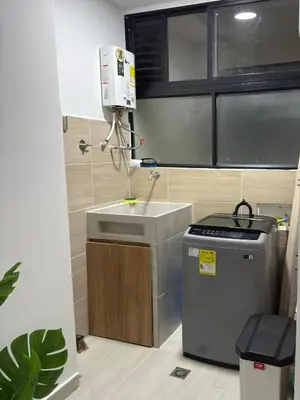 a small kitchen with a sink and a stove at Nuevo apartamento en plaza principal de Guatape in Guatapé