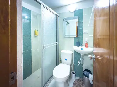 a bathroom with a toilet and a sink and a shower at Laureles Coliving House Medellín in Medellín