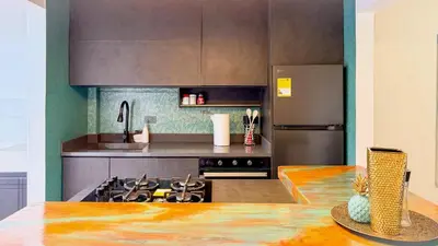 a kitchen with a stove and a refrigerator at Laureles Coliving House Medellín in Medellín