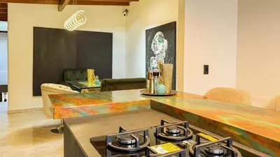 a kitchen with a stove top in a room at Laureles Coliving House Medellín in Medellín