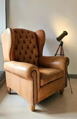 a brown leather chair with a camera on a tripod at Exclusive penthouse in Provenza in Medellín
