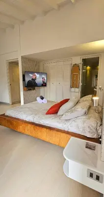 a large bed in a room with a flat screen tv at Exclusive penthouse in Provenza in Medellín