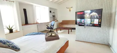 a bedroom with a bed and a flat screen tv at Exclusive penthouse in Provenza in Medellín