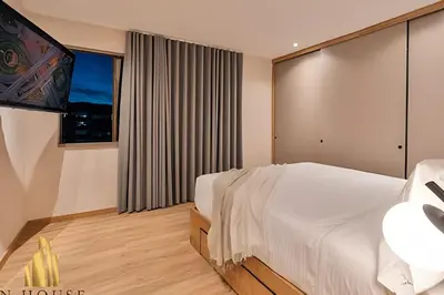 a bedroom with a large bed and a large window at Tivoli 202 - Escapada Premium con Jacuzzi Privado in Medellín