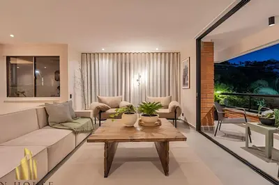 a living room with a couch and a table at Tivoli 202 - Escapada Premium con Jacuzzi Privado in Medellín