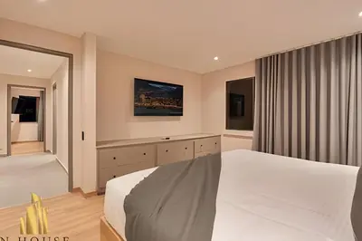 a bedroom with a white bed and a window at Tivoli 202 - Escapada Premium con Jacuzzi Privado in Medellín