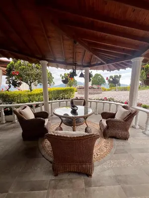 a patio with a table and chairs on a porch at Casablanca Hotel Boutique Salamina in Salamina