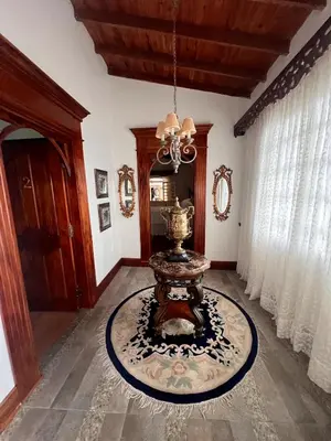 a living room with a table and a chandelier at Casablanca Hotel Boutique Salamina in Salamina