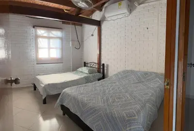 a bedroom with two beds and a window at Casa refugio Natural in Puerto Triunfo