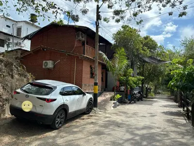 a white car parked in front of a brick building at Casa refugio Natural in Puerto Triunfo