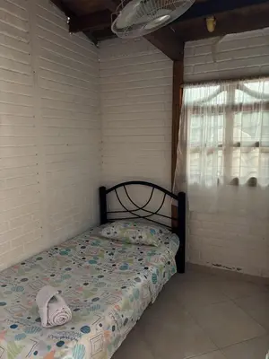 a bedroom with a bed in a room with a window at Casa refugio Natural in Puerto Triunfo