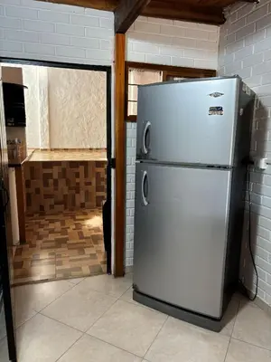 a white refrigerator in a kitchen with a counter at Casa refugio Natural in Puerto Triunfo