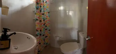 a bathroom with a toilet and a sink and a shower at Casa refugio Natural in Puerto Triunfo