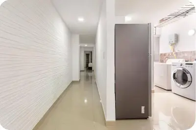 a kitchen with a refrigerator and a washer and dryer at Group Stay in Poblado - Walk Everywhere - King Bed in Medellín