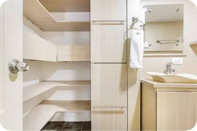 a small bathroom with white cabinets and a sink at Group Stay in Poblado - Walk Everywhere - King Bed in Medellín