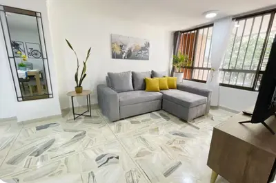 a living room with a couch and a table at Group Stay in Poblado - Walk Everywhere - King Bed in Medellín