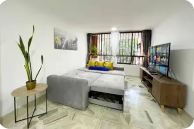 a living room with a couch and a television at Group Stay in Poblado - Walk Everywhere - King Bed in Medellín