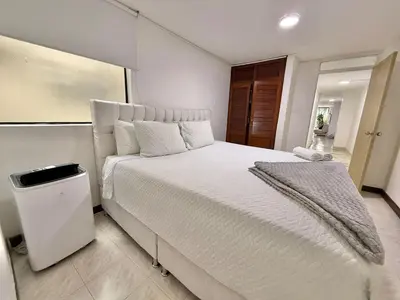 a bedroom with a large white bed in a room at Medellin Poblado Gem Walk to Provenza and Lleras in Medellín