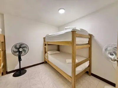 a room with a bunk bed and a fan at Medellin Poblado Gem Walk to Provenza and Lleras in Medellín
