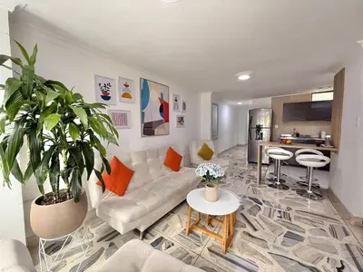 a living room with a couch and a table at Medellin Poblado Gem Walk to Provenza and Lleras in Medellín