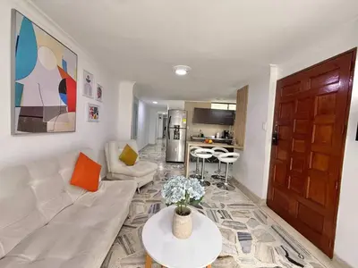a living room with a couch and a table at Medellin Poblado Gem Walk to Provenza and Lleras in Medellín