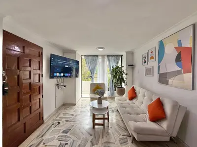 a living room with a couch and a table at Medellin Poblado Gem Walk to Provenza and Lleras in Medellín