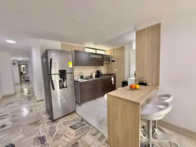 a kitchen with a stainless steel refrigerator and a counter at Medellin Poblado Gem Walk to Provenza and Lleras in Medellín