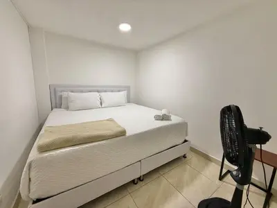 a small bedroom with a bed and a desk at Poblado Gem Walk to Provenza and Steps to Cafes in Medellín