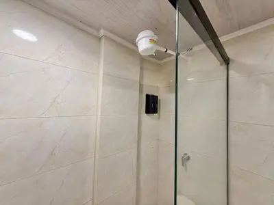 a bathroom with a shower with a glass door at Poblado Gem Walk to Provenza and Steps to Cafes in Medellín