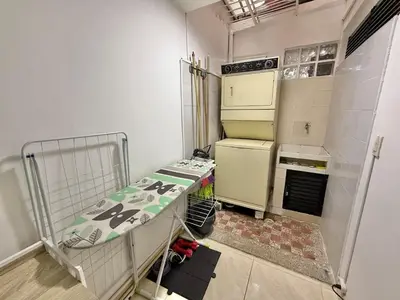 a small kitchen with a stove and a refrigerator at Poblado Gem Walk to Provenza and Steps to Cafes in Medellín