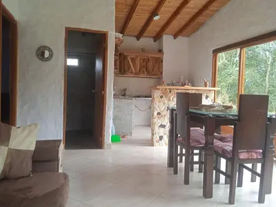 a kitchen with a table and chairs in a room at Cabaña campestre in Medellín