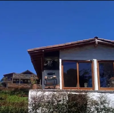 a small house with a window on the side of it at Cabaña campestre in Medellín