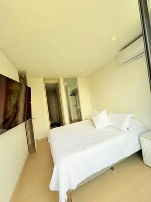 a bedroom with a large white bed with white sheets at Poblado de lujo in Medellín