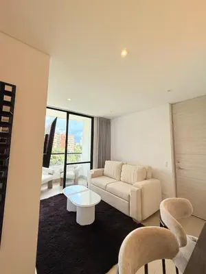 a living room with a couch and a table at Poblado de lujo in Medellín
