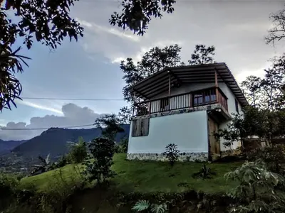 a house on top of a hill with a view at Country cabin with panoramic view among clouds - cabaña refugio entre nubes in Támesis