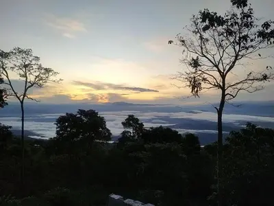 a sunset with trees and clouds in the sky at Country cabin with panoramic view among clouds - cabaña refugio entre nubes in Támesis