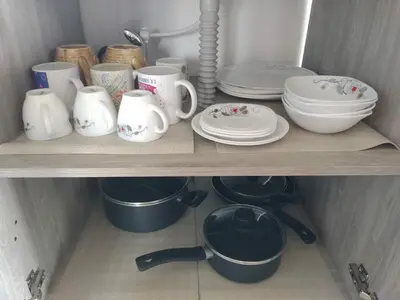 a shelf with dishes and cups and plates on it at Country cabin with panoramic view among clouds - cabaña refugio entre nubes in Támesis