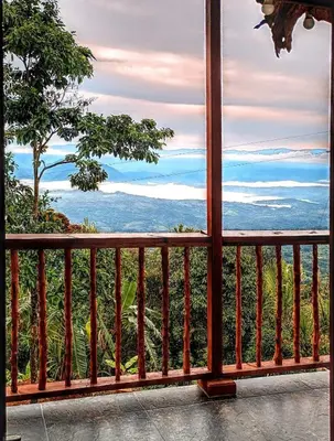 a view of the ocean from a balcony at Country cabin with panoramic view among clouds - cabaña refugio entre nubes in Támesis